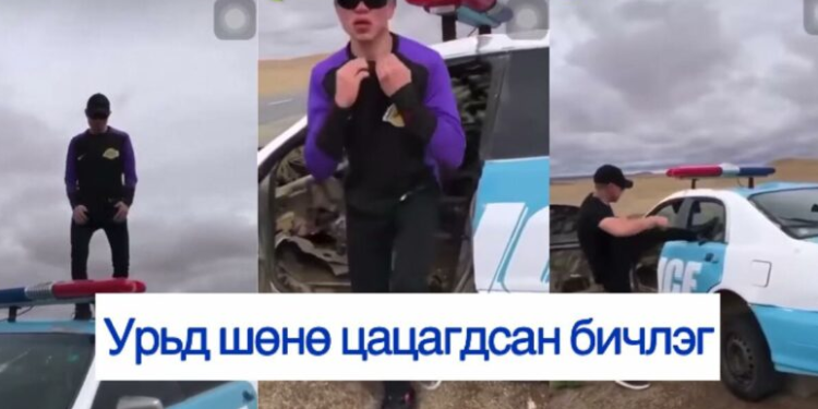 Цагдаагийн машины цонхыг хагалж, дээр нь бүжиглэсэн залуу …